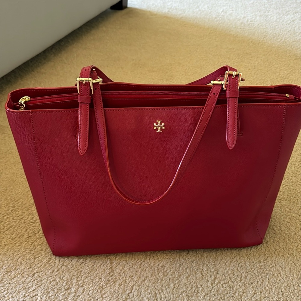 Red Tory Burch tote and matching red wallet.